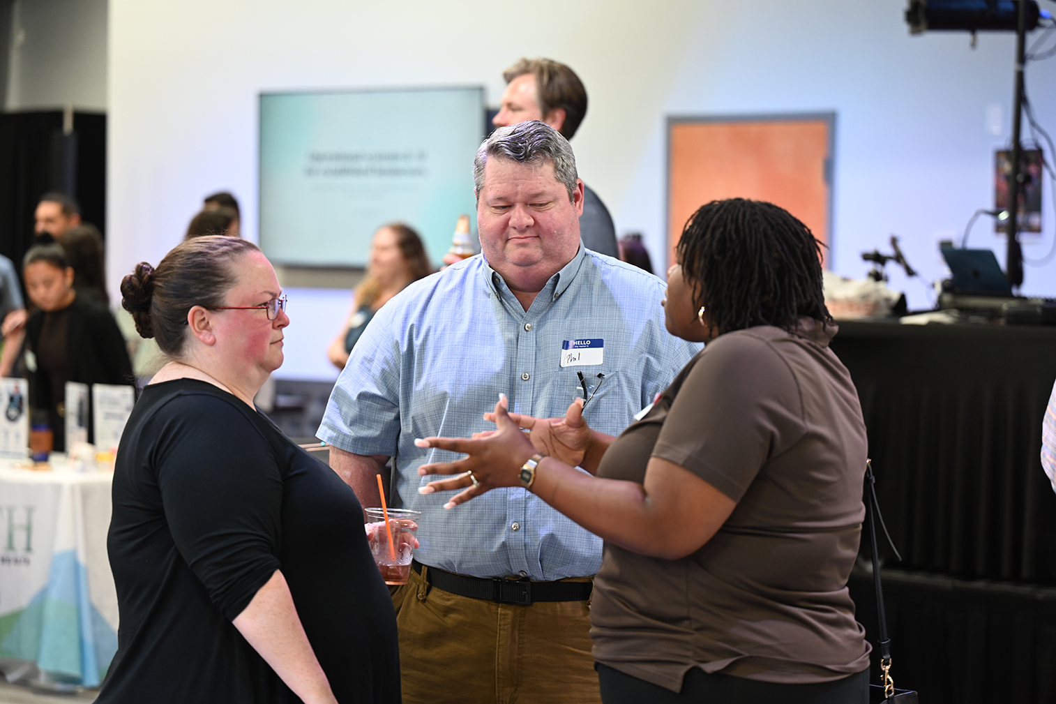 Melissa and Phil Beck talking with a business owner